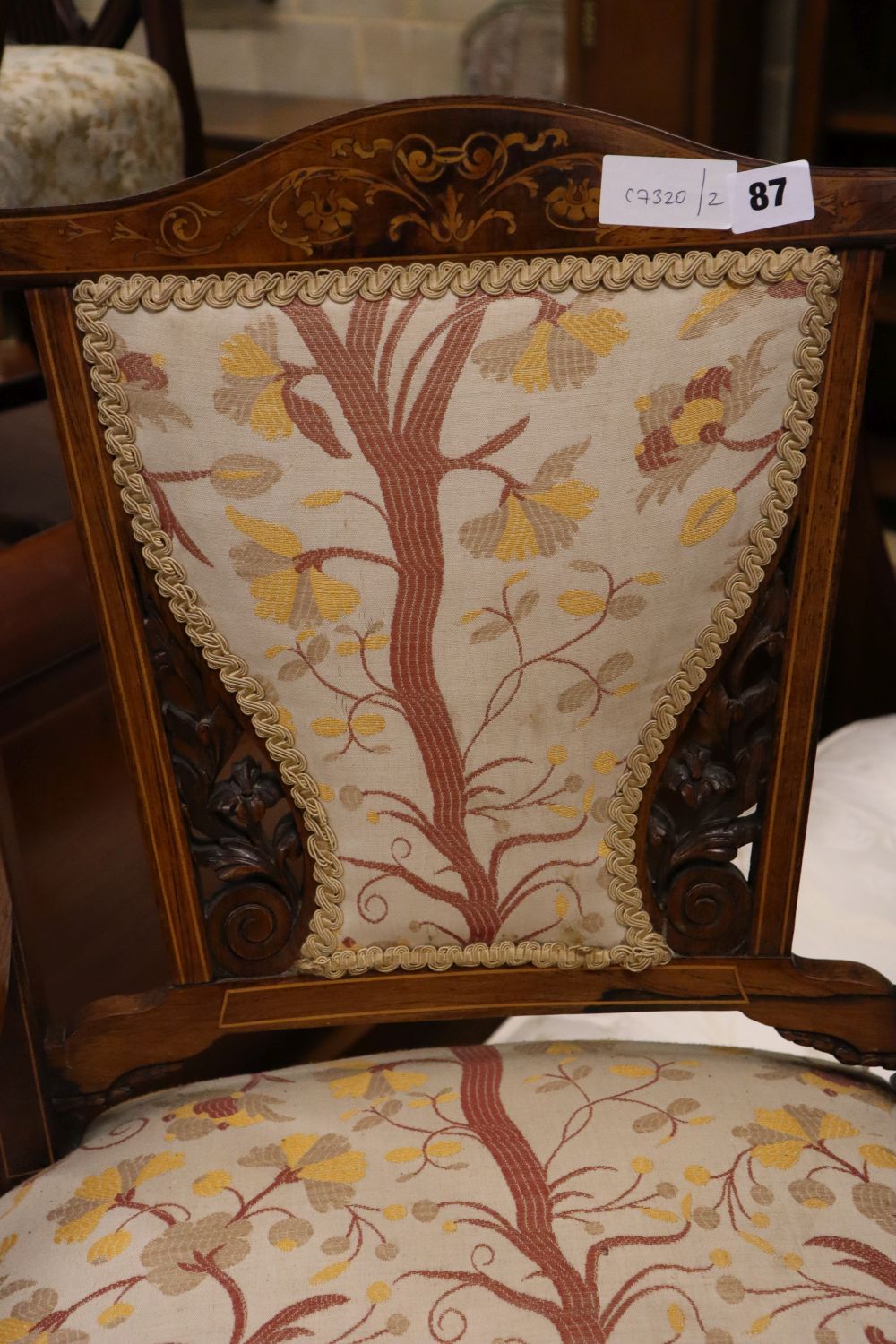 A late Victorian marquetry inlaid rosewood low seat chair